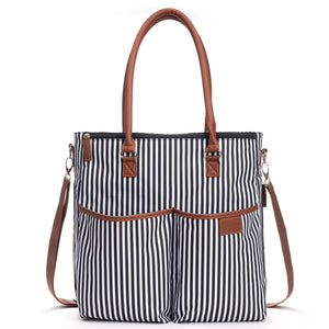 Designer Baby Diaper Bag In Classic Black And White With Matching Changing Pad, Pacifier Pod, And Two Pacifier Clips