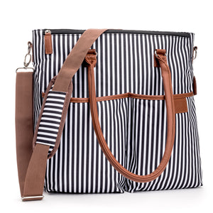 Designer Baby Diaper Bag In Classic Black And White With Matching Changing Pad, Pacifier Pod, And Two Pacifier Clips