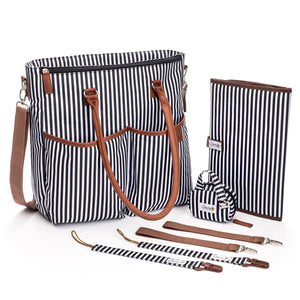 Designer Baby Diaper Bag In Classic Black And White With Matching Changing Pad, Pacifier Pod, And Two Pacifier Clips
